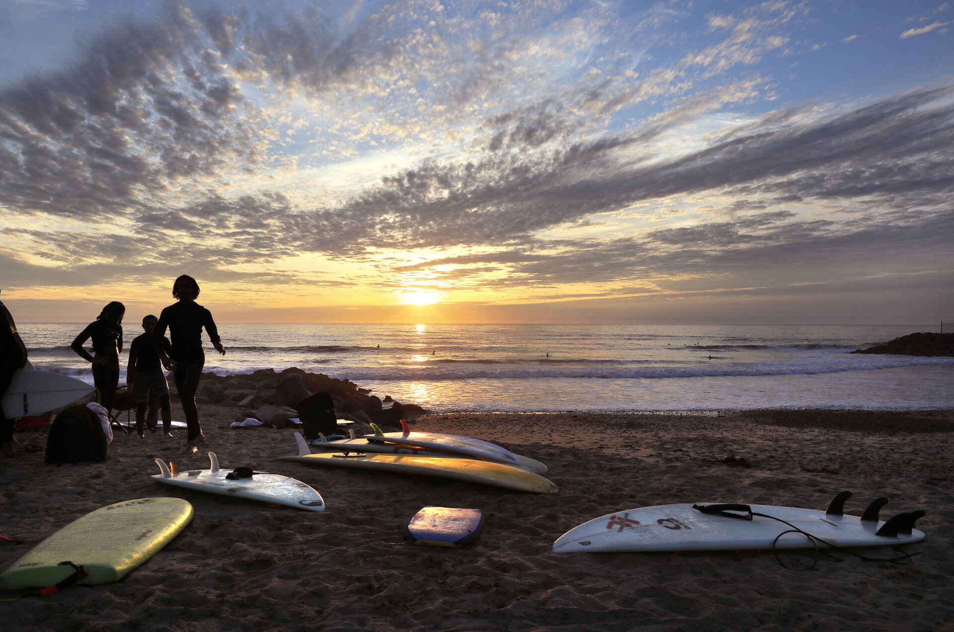 surfers at dusk