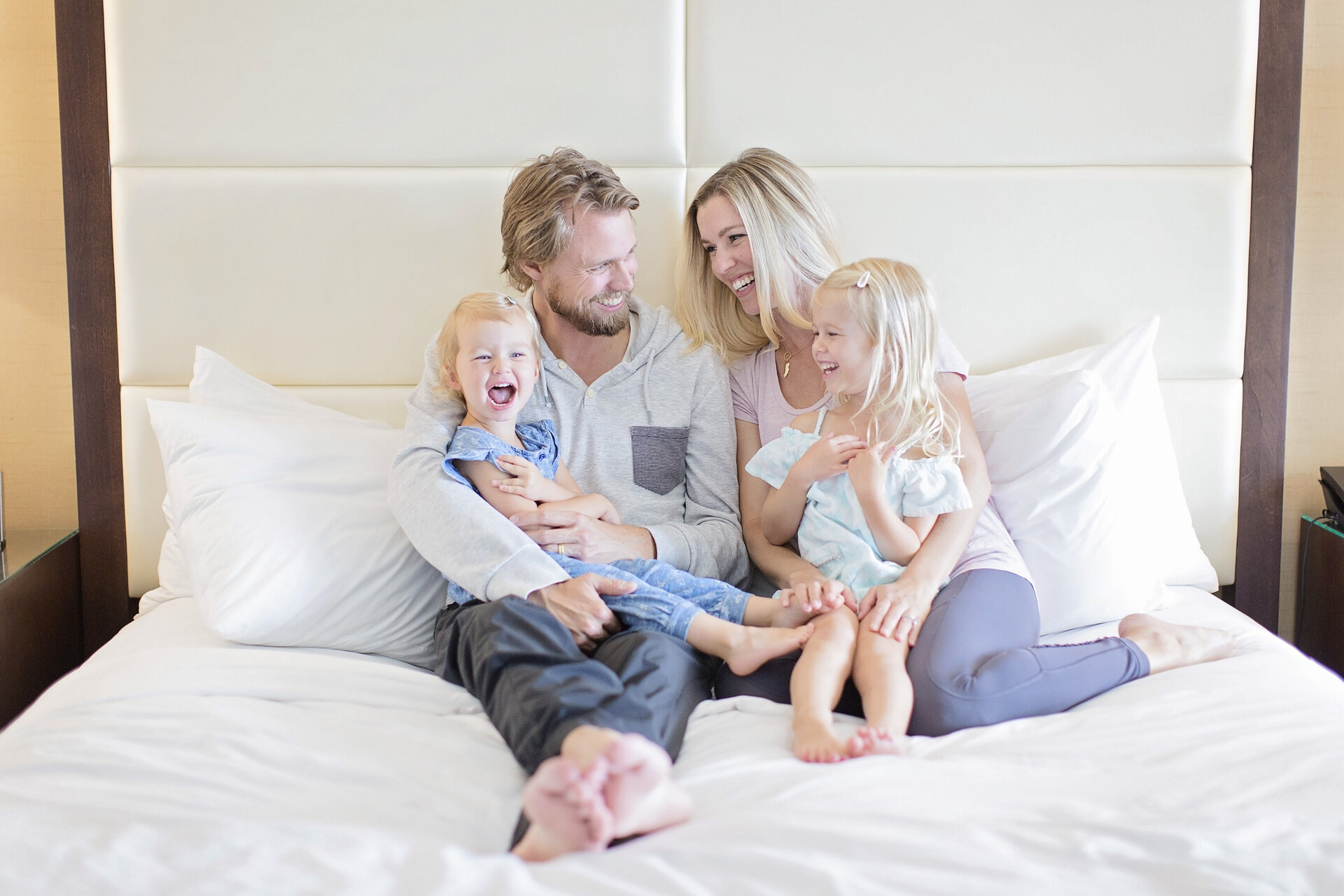 family sitting on a bed