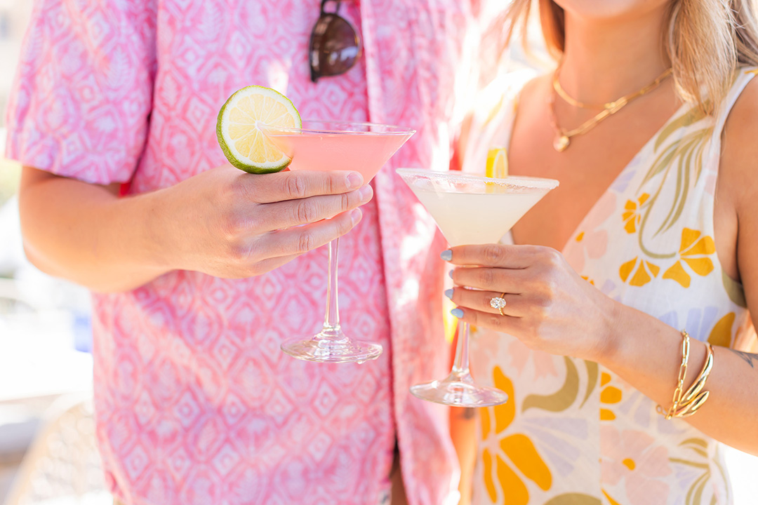 a couple of people holding drinks