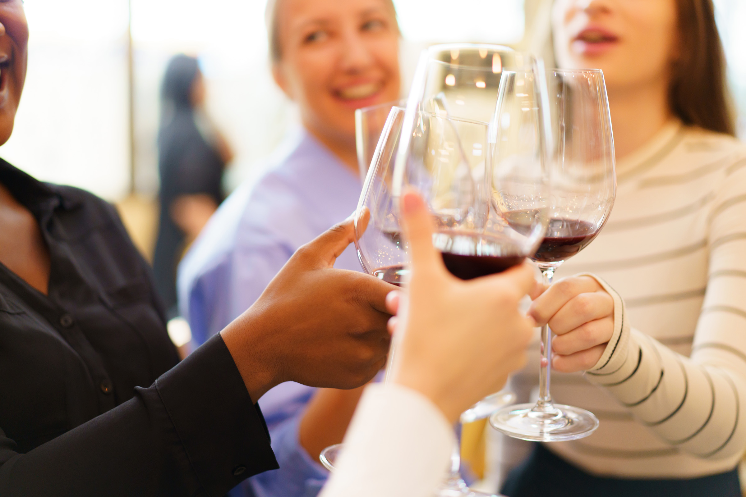 a group of people holding wine glasses