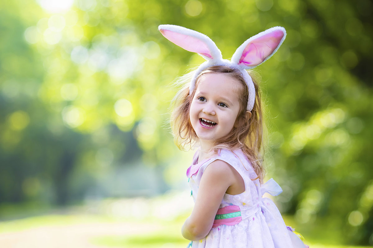 a girl wearing bunny ears and smiling